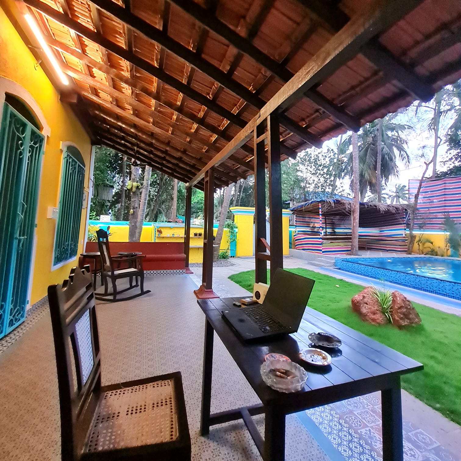 Office balcony work desk — open-air workspace with garden view, perfect for digital nomads