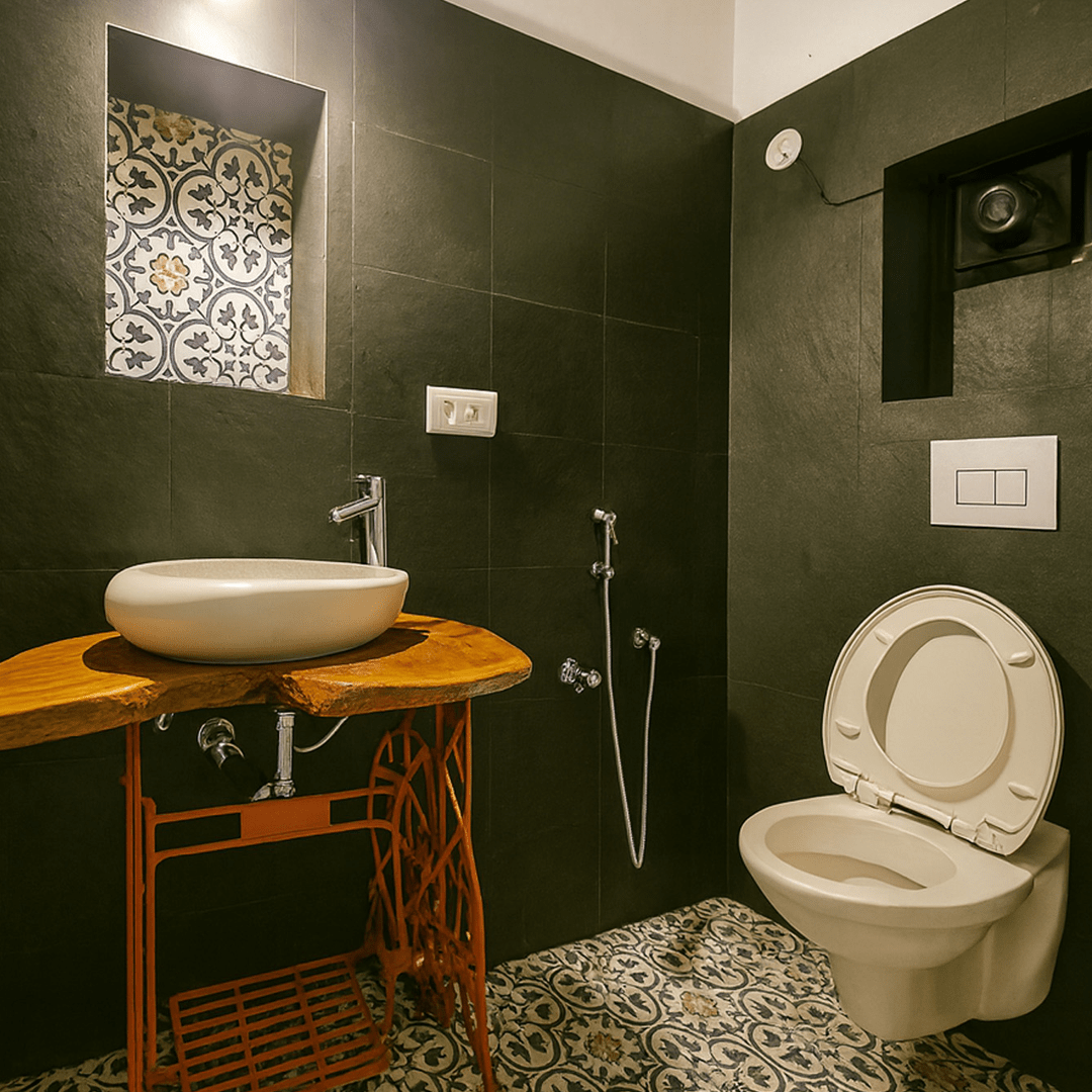 Unique handmade bathroom sink platform at goco.life Goa - a soft rounded basin on a repurposed vintage sewing machine frame, finished in orange with a natural live-edge wood platform.