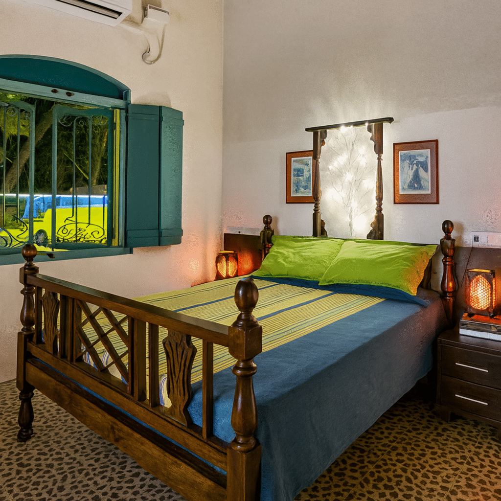 Nana's Room at Valentine Villa - a spacious heritage bedroom with high ceilings, original Portuguese details, a comfortable sitting area, and modern amenities for a luxurious family stay in Goa.